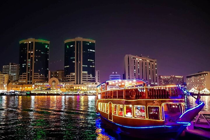 Cruise along Dubai's Marina on a charming dhow soaking in stunning views savoring international cuisine and enjoying delightful live music for an unforgettable evening.
